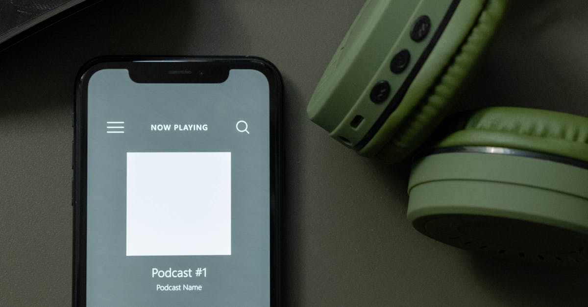 Modern smartphone and green headphones next to a magazine, showcasing technology and lifestyle.